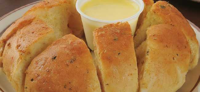 Crazy Bread on a plate with butter cup in center.