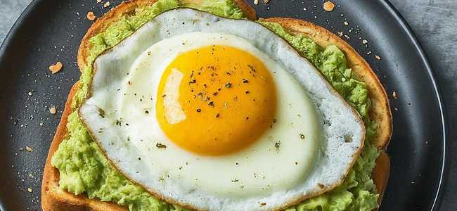 Avocado toast on a plate topped with an egg.